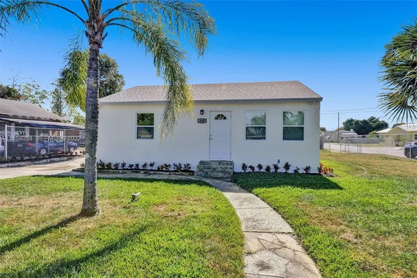 a view of a backyard with swimming pool