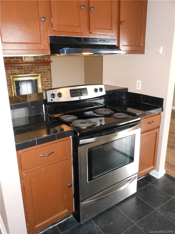 11054 Running Ridge Road, Unit 8415 Charlotte, NC 28226 - Photo 5 of 24 a stove top oven sitting inside of a kitchen