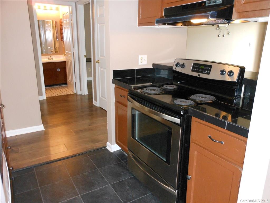 11054 Running Ridge Road, Unit 8415 Charlotte, NC 28226 - Photo 6 of 24 a stove top oven sitting inside of a kitchen