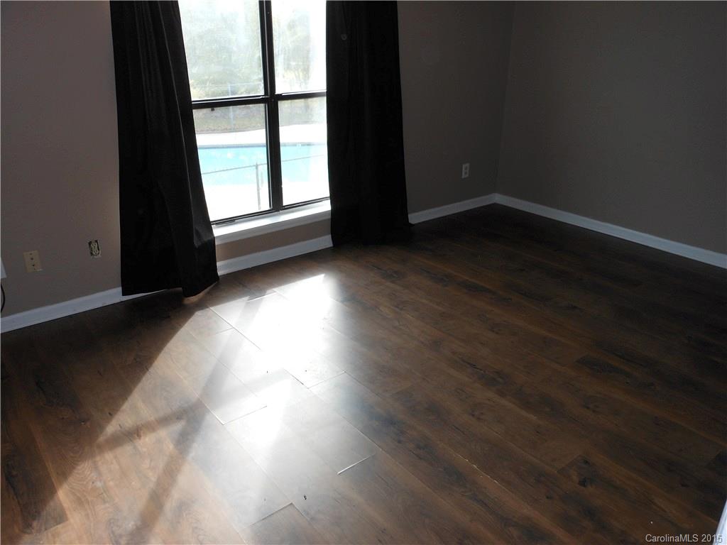 11054 Running Ridge Road, Unit 8415 Charlotte, NC 28226 - Photo 10 of 24 a view of a room with wooden floor and windows