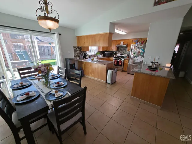 a kitchen with a dining table and chairs