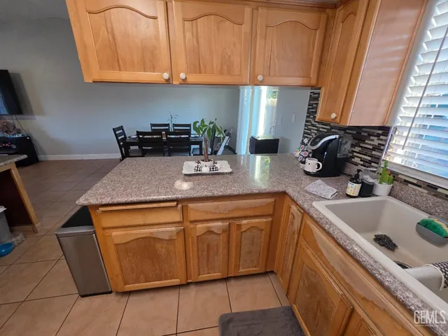 a kitchen with sink and cabinets