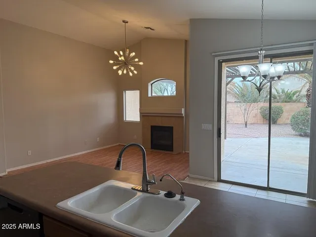 a view of a room with a ceiling fan and a fireplace