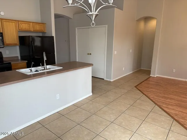 a kitchen with kitchen island cabinets and sink