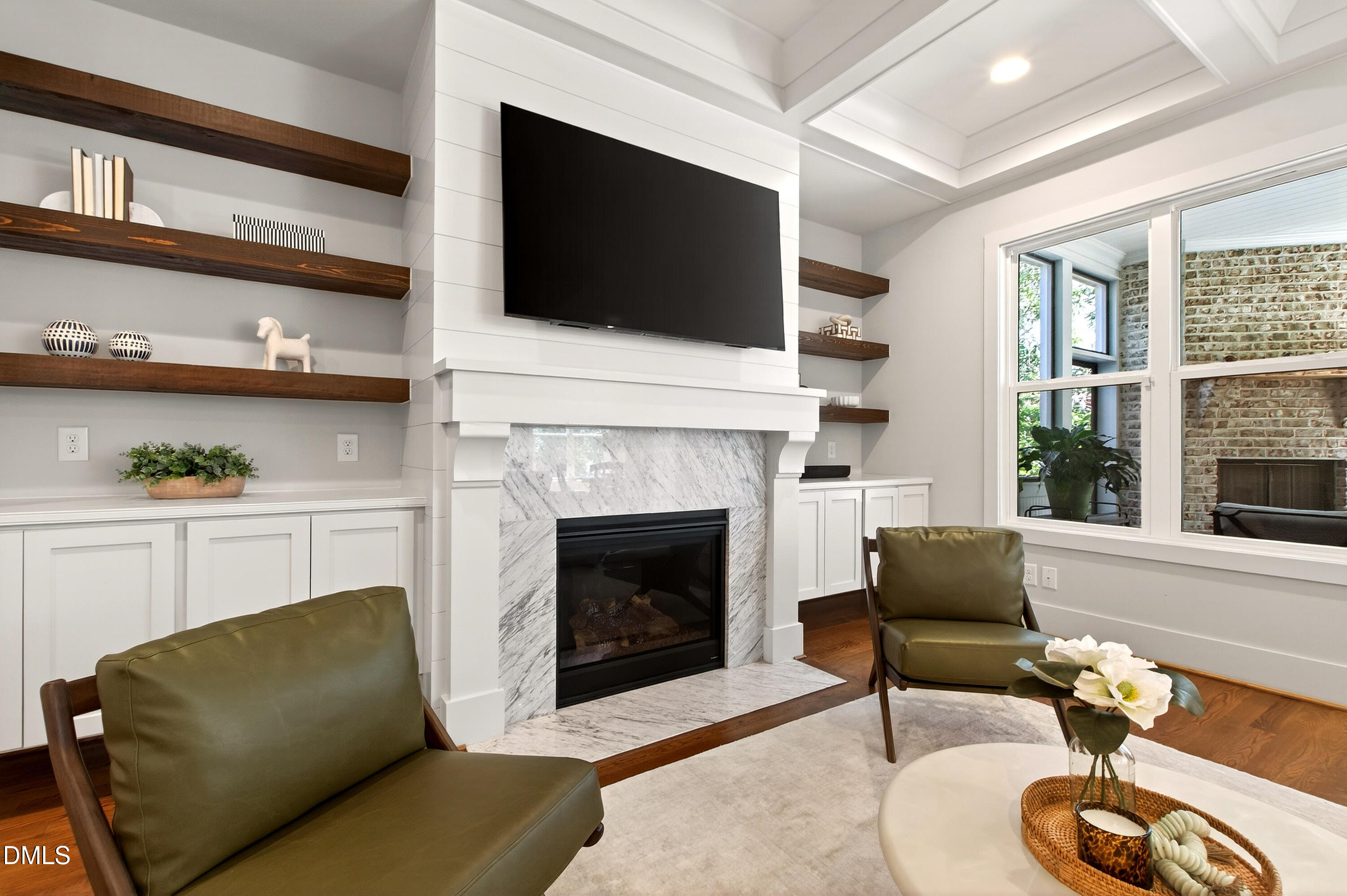1116 Hymettus Court Raleigh, NC 27607 - Photo 22 of 69 a living room with furniture a fireplace and a flat screen tv