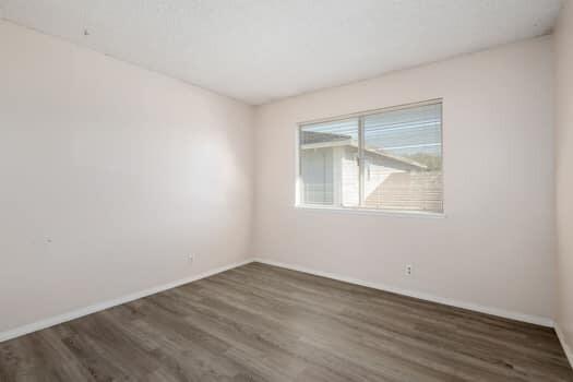5940 Birch Street, Unit 2 Carpinteria, CA 93013 - Photo 11 of 17 an empty room with wooden floor and windows