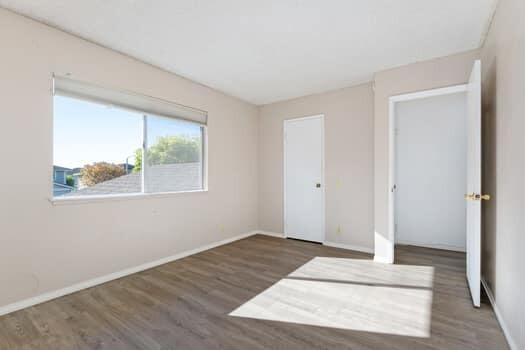 5940 Birch Street, Unit 2 Carpinteria, CA 93013 - Photo 12 of 17 a view of an empty room with wooden floor and a window