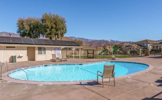 5940 Birch Street, Unit 2 Carpinteria, CA 93013 - Photo 15 of 17 a view of a house with pool fire pit and chairs