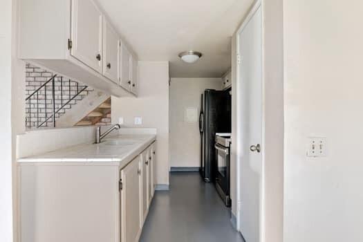 5940 Birch Street, Unit 2 Carpinteria, CA 93013 - Photo 8 of 17 a kitchen with a sink and refrigerator