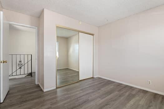 5940 Birch Street, Unit 2 Carpinteria, CA 93013 - Photo 10 of 17 an empty room with wooden floor & door