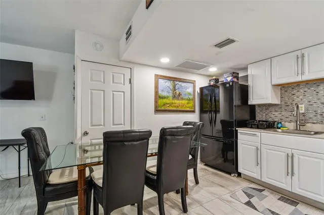 a view of a dining room with furniture and a kitchen