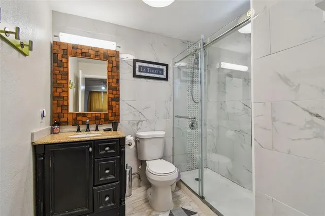 a bathroom with a toilet a sink and shower