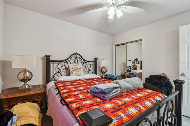 a bedroom with a bed and ceiling fan