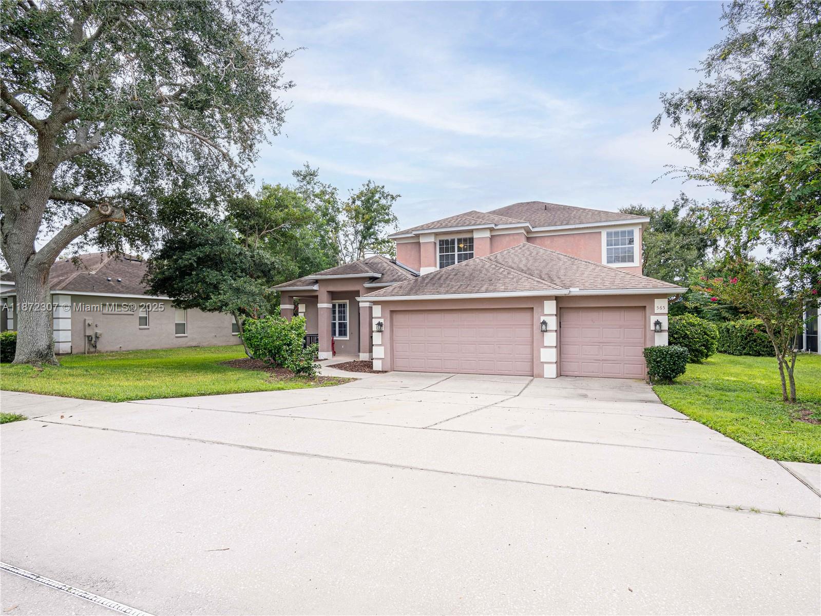 565 Hebrides Court Apopka, FL 32712 - Photo 2 of 32 a front view of house with yard and trees