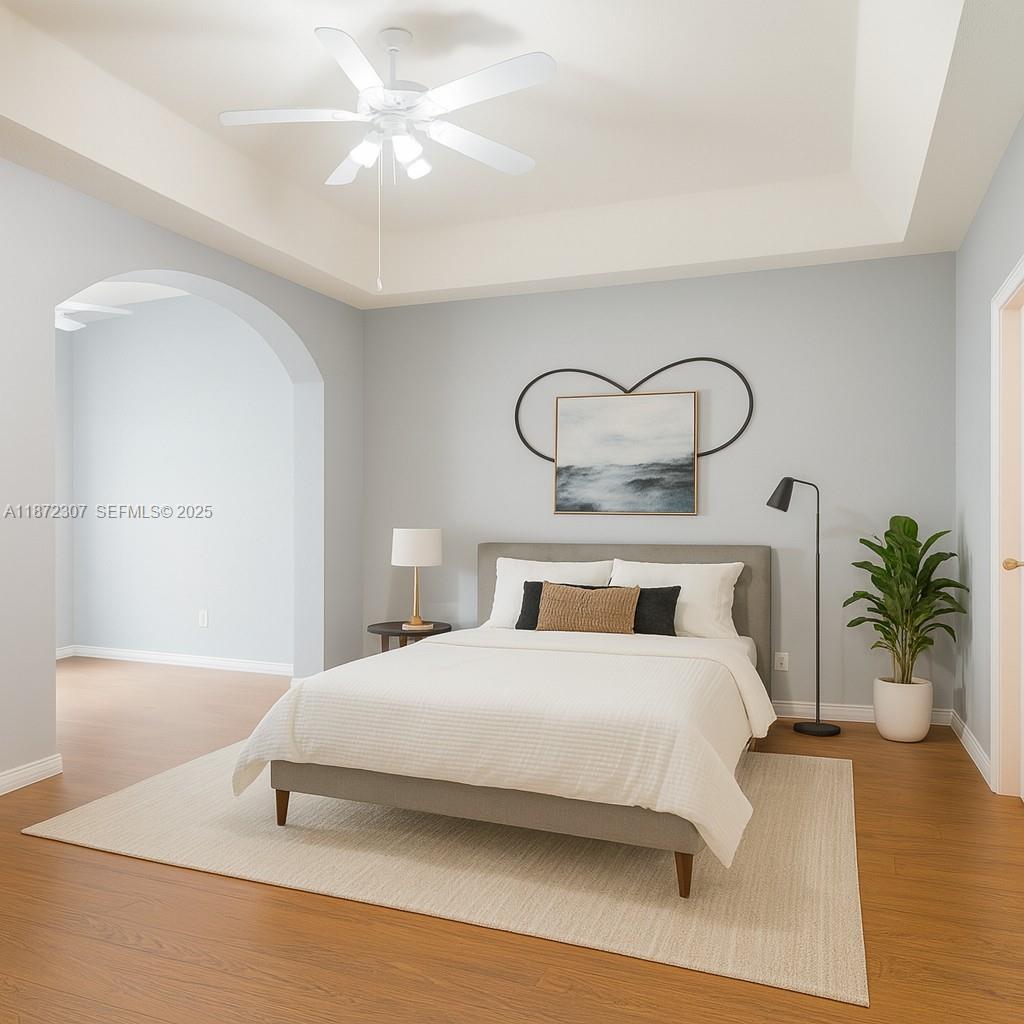 565 Hebrides Court Apopka, FL 32712 - Photo 21 of 32 a bedroom with a bed and a chandelier