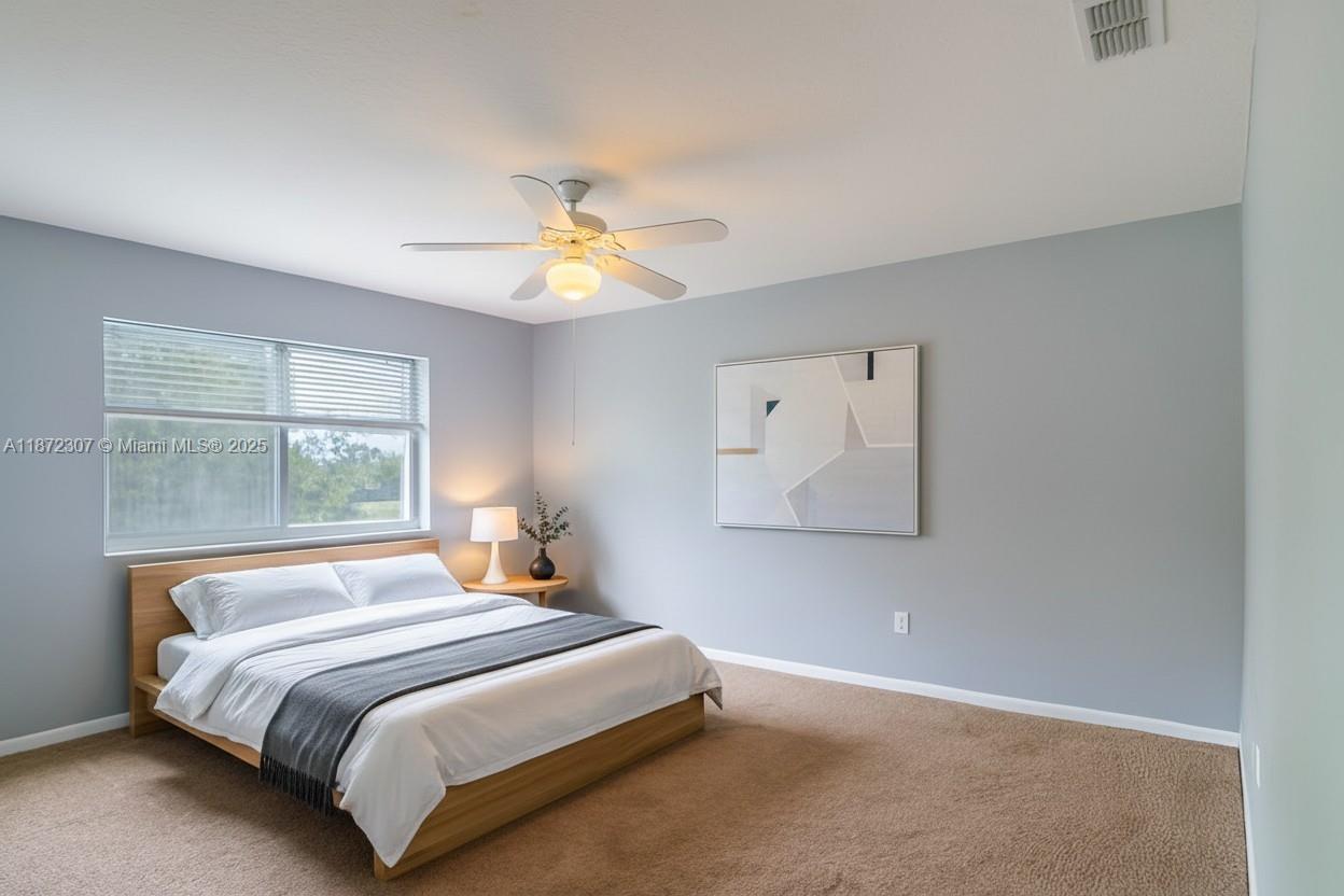 565 Hebrides Court Apopka, FL 32712 - Photo 9 of 32 a bedroom with a bed and a window