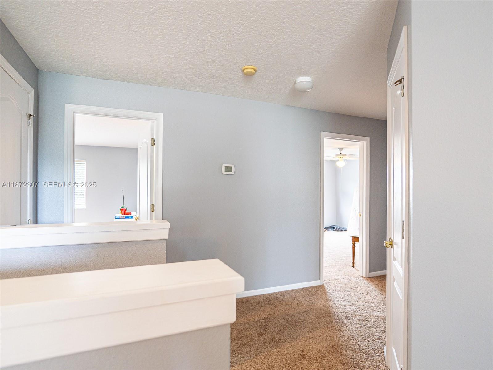 565 Hebrides Court Apopka, FL 32712 - Photo 10 of 32 a bathroom with a sink and a mirror