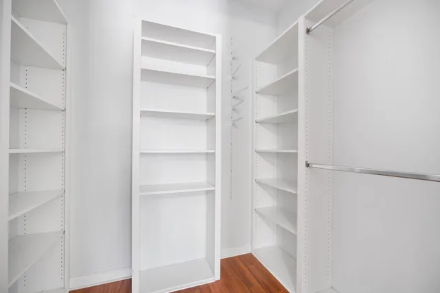 a view of walk in closet with empty racks