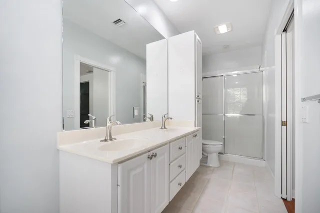 a bathroom with a double vanity sink mirror and double