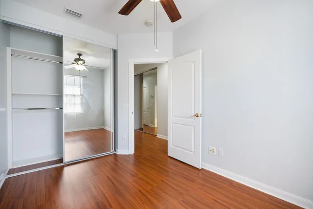 a view of empty room with wooden floor