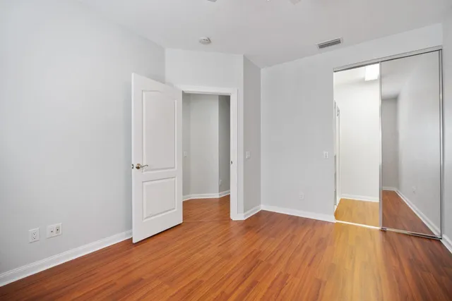 a view of empty room with wooden floor
