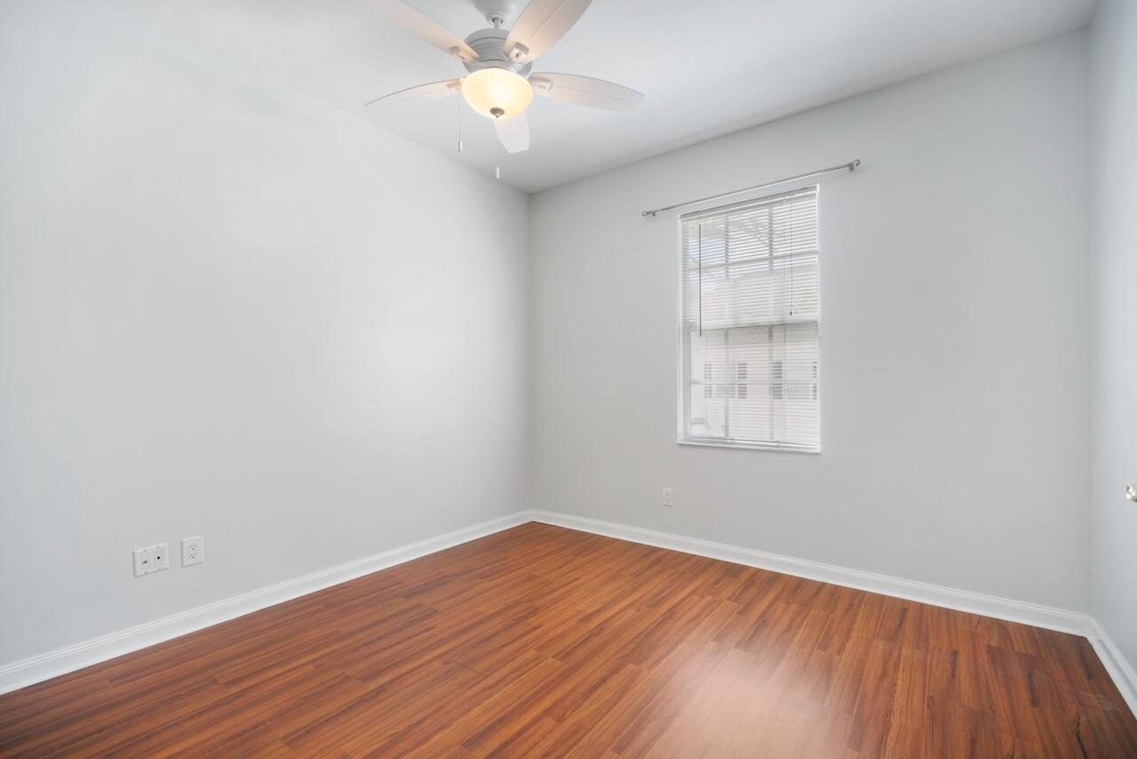 329 Legare Court Jupiter, FL 33458 - Photo 19 of 23 an empty room with wooden floor and windows