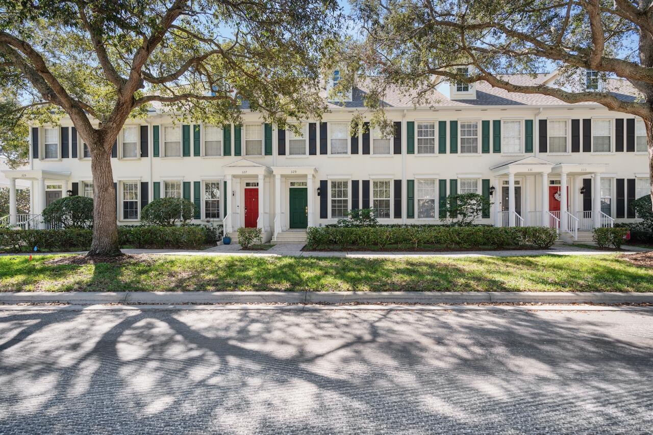 329 Legare Court Jupiter, FL 33458 - Photo 22 of 23 a front view of a house with a yard and plants