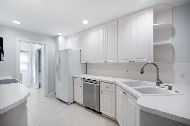 a kitchen with a sink and refrigerator