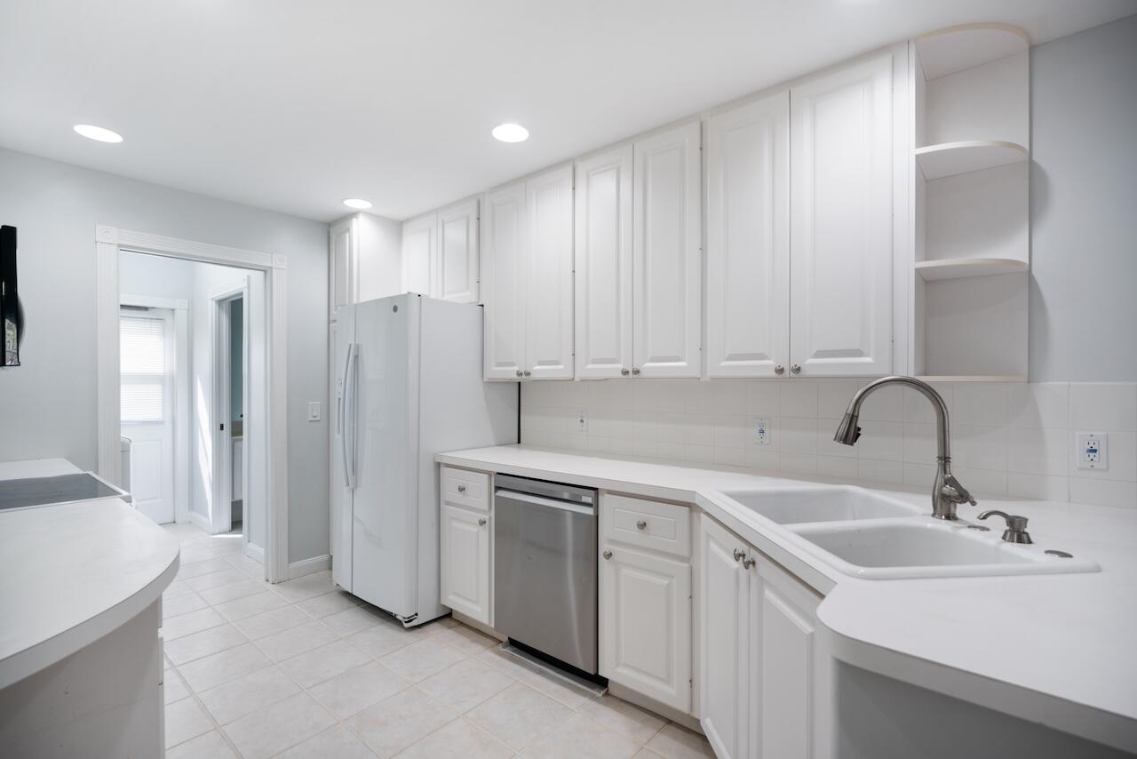 329 Legare Court Jupiter, FL 33458 - Photo 6 of 23 a kitchen with a sink and refrigerator