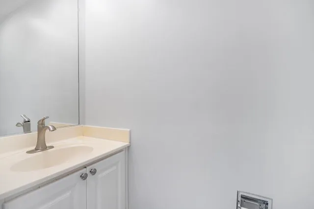 a bathroom with a sink and vanity