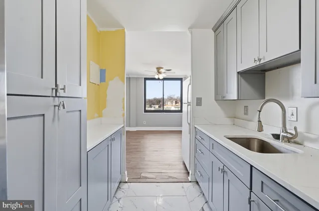 a kitchen with stainless steel appliances granite countertop a sink and a refrigerator