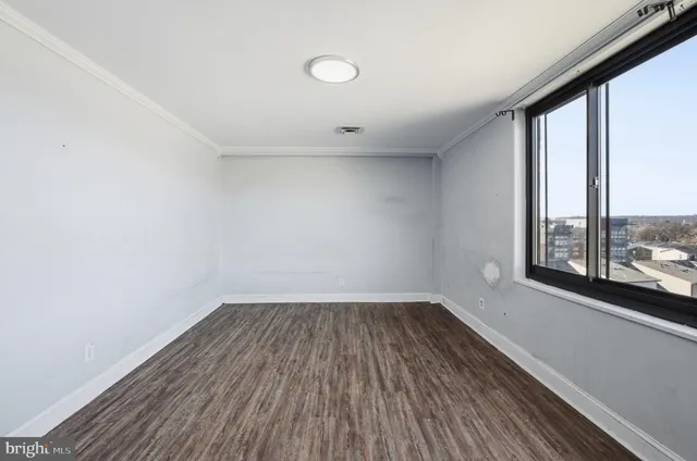 a view of a room with wooden floor and iron stairs