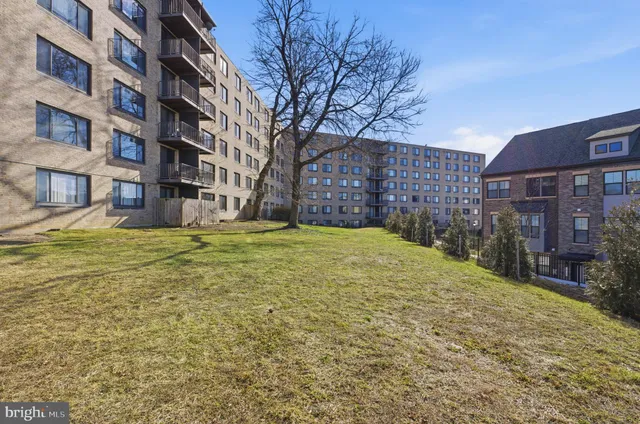a view of a brick building next to a yard