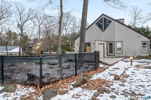 a view of a white house with a yard and covered with snow
