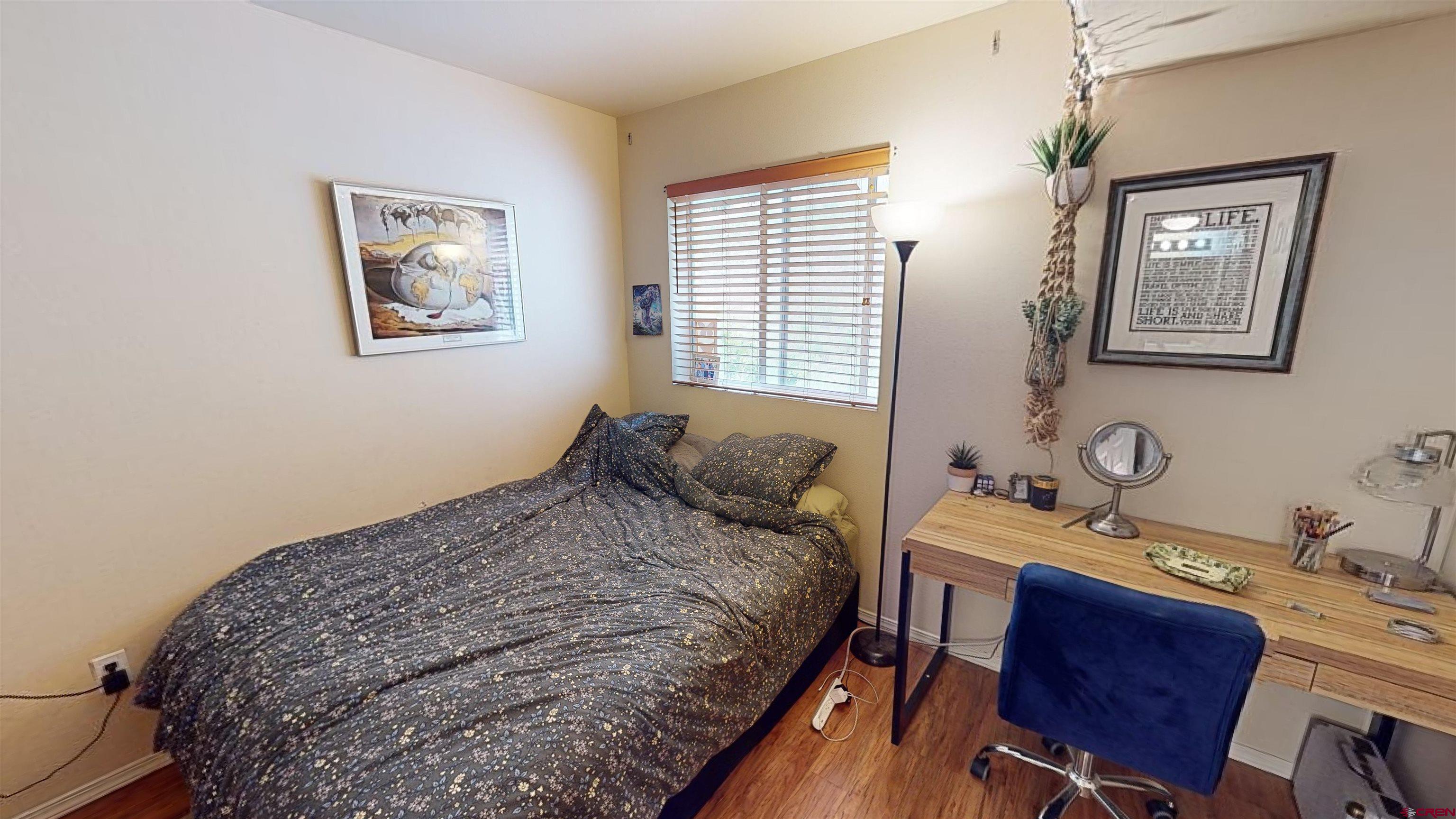 1100 Goeglein Gulch Road, Unit 162 Durango, CO 81301 - Photo 12 of 34 a bedroom with a bed and a table in it