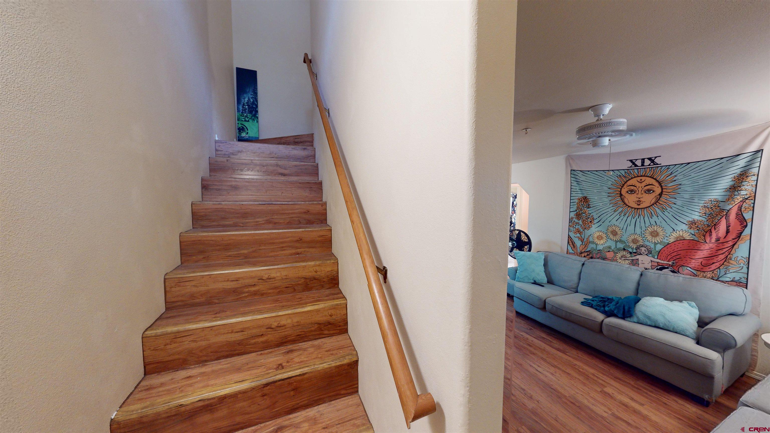 1100 Goeglein Gulch Road, Unit 162 Durango, CO 81301 - Photo 16 of 34 a living room with furniture and a stairs