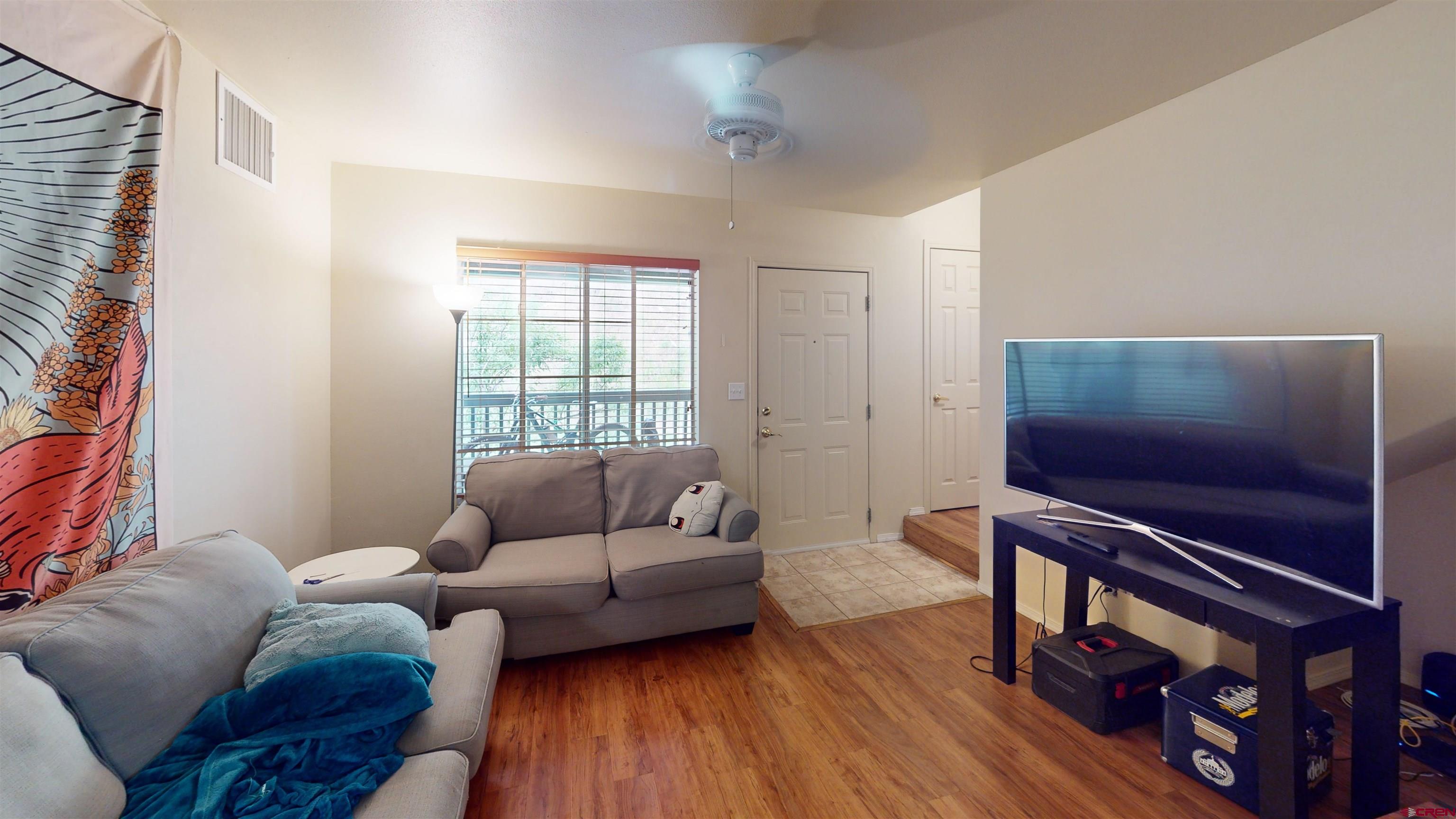 1100 Goeglein Gulch Road, Unit 162 Durango, CO 81301 - Photo 2 of 34 a living room with furniture and a flat screen tv