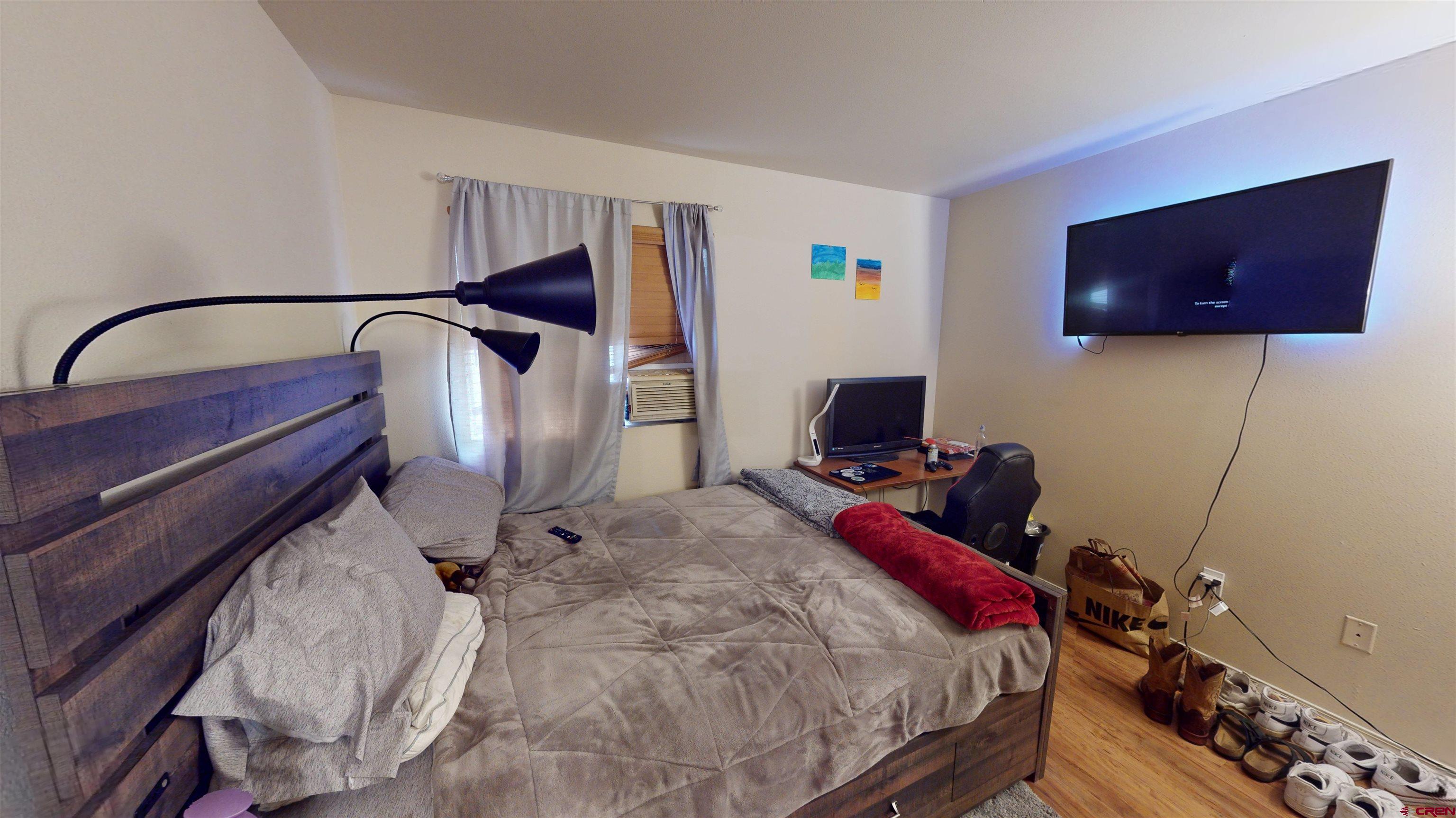 1100 Goeglein Gulch Road, Unit 162 Durango, CO 81301 - Photo 23 of 34 a bedroom with a bed and a flat screen tv