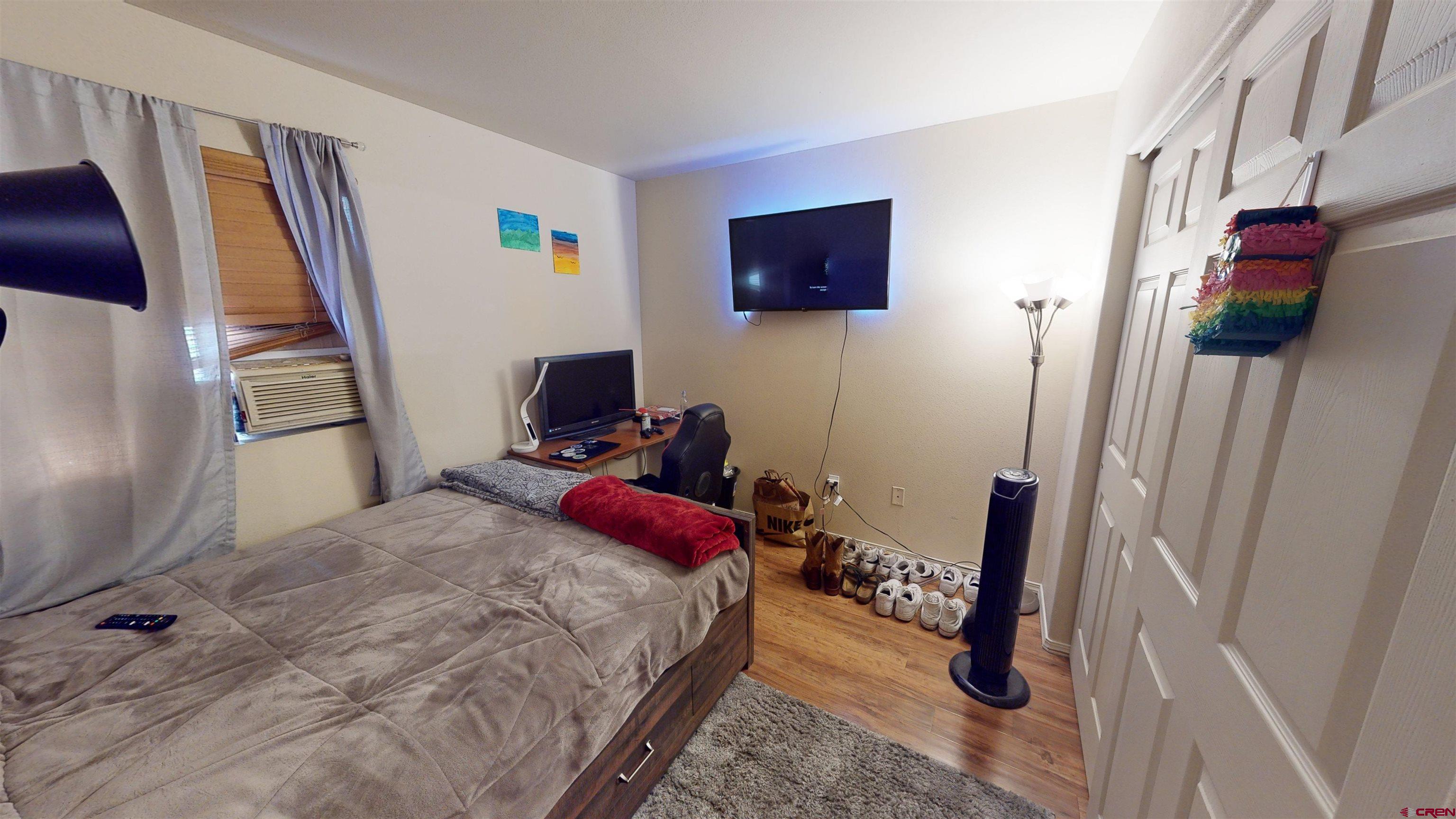 1100 Goeglein Gulch Road, Unit 162 Durango, CO 81301 - Photo 24 of 34 a bedroom with a bed and a mirror