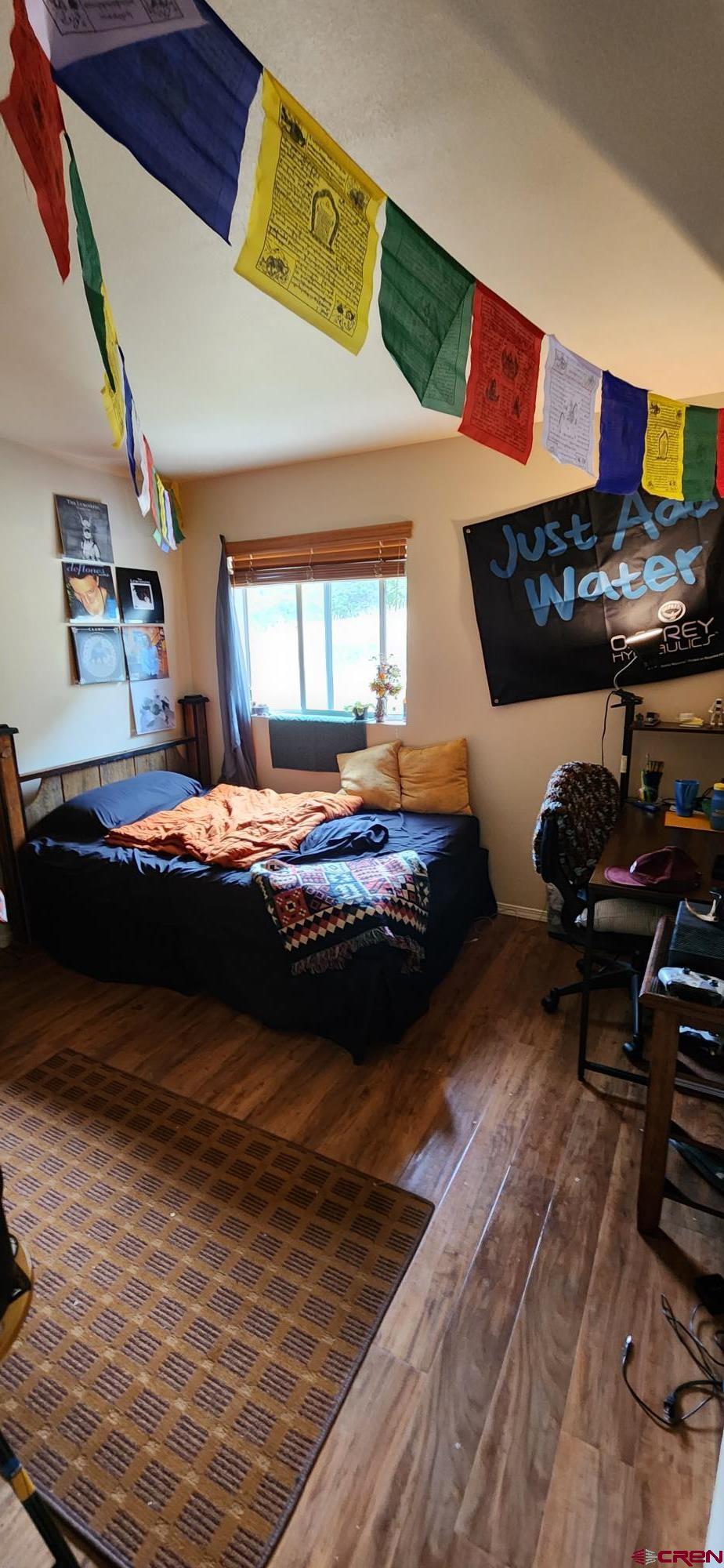 1100 Goeglein Gulch Road, Unit 162 Durango, CO 81301 - Photo 29 of 34 a bedroom with furniture and a mirror