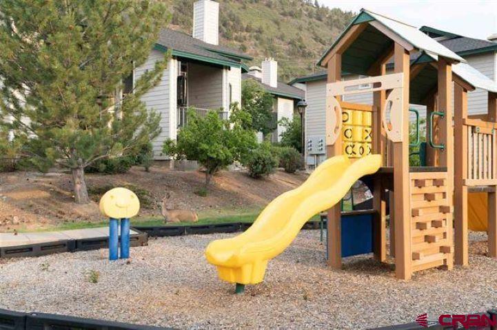 1100 Goeglein Gulch Road, Unit 162 Durango, CO 81301 - Photo 32 of 34 a view of a chair and tables in the patio