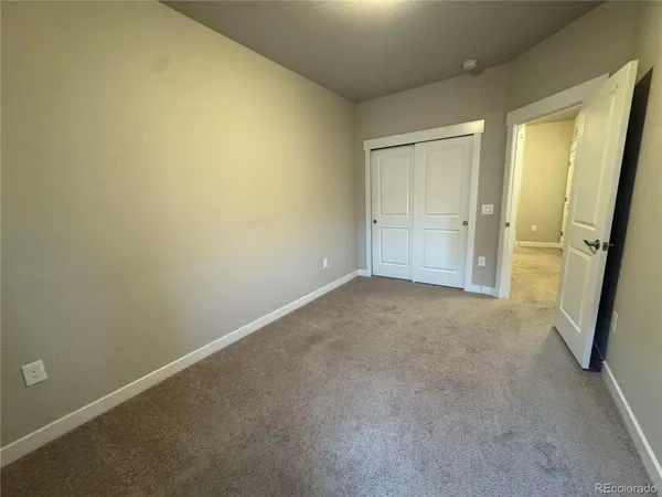 a bathroom with a granite countertop sink toilet a mirror a bathtub and shower