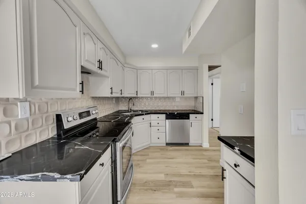 a kitchen with a sink stove and cabinets