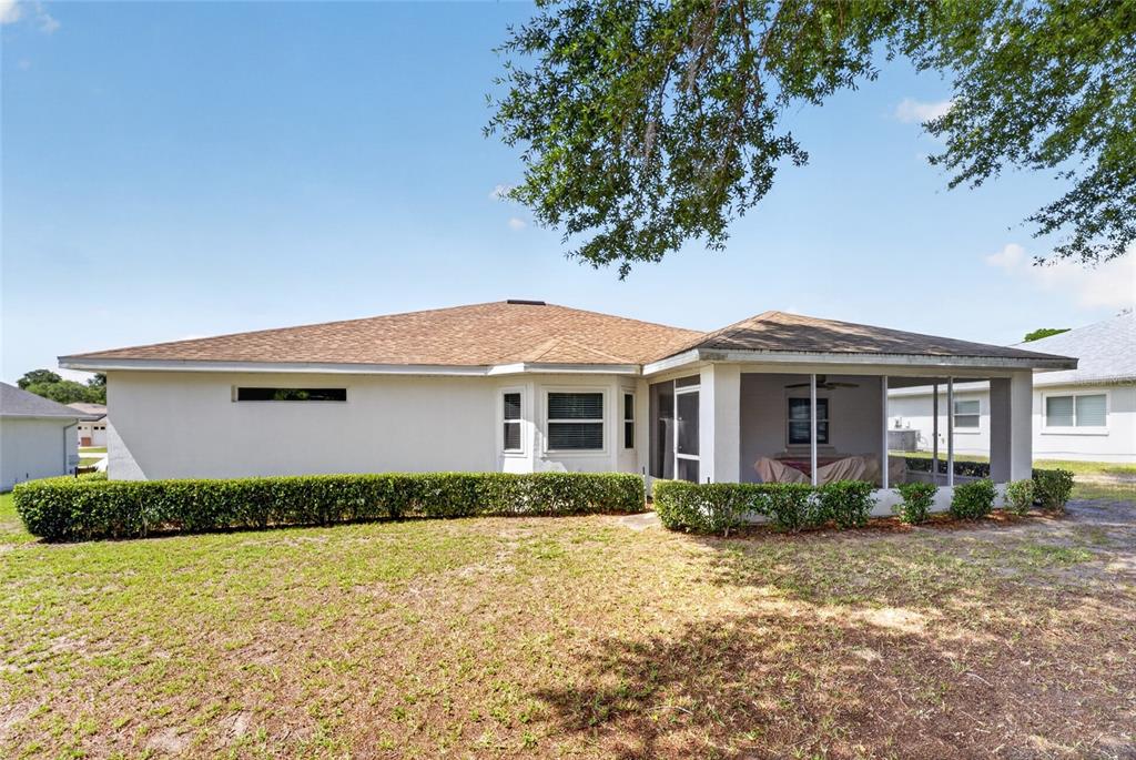 6032 Southwest 103rd Loop Ocala, FL 34476 - Photo 23 of 28 a front view of a house with a garden