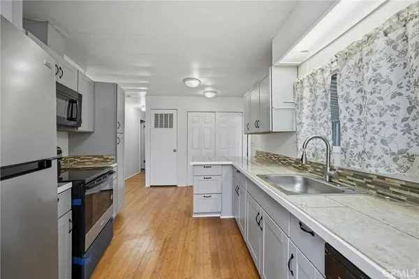 a kitchen with a sink stove and refrigerator