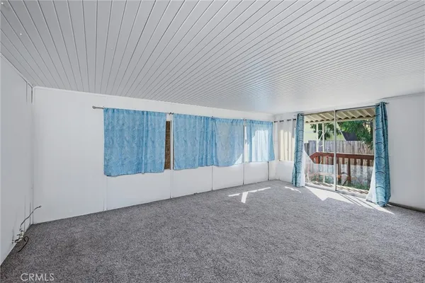 a view of an empty room with glass door