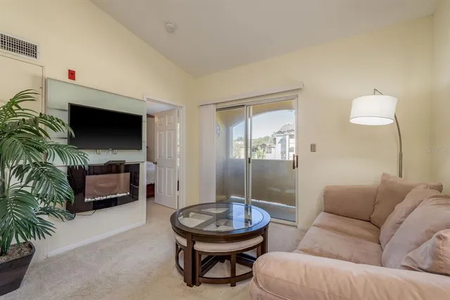 a living room with furniture flowerpot and a chandelier