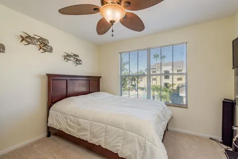 a bedroom with a large bed and a potted plant