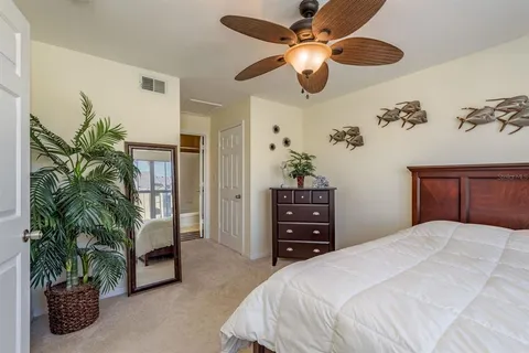a bathroom with a granite countertop double vanity sink and mirror