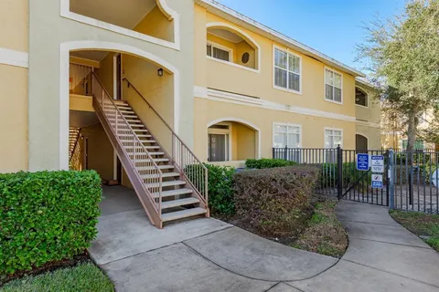 a view of a house with swimming pool and sitting area
